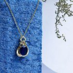 Gold Necklace Embellished With Sparkling Zircon Stones And A Large Colorful Gem