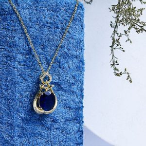 Gold Necklace Embellished With Sparkling Zircon Stones And A Large Colorful Gem