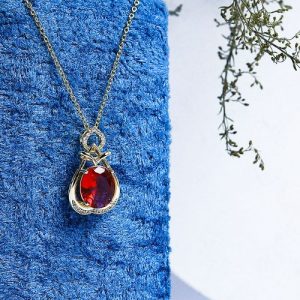 Gold Necklace Embellished With Sparkling Zircon Stones And A Large Colorful Gem