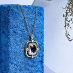 Luxurious Gold Necklace With Shimmering Zircon Stones And A Prominent Colorful Gem