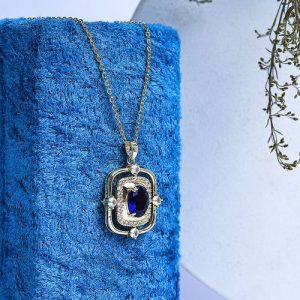 Luxurious Gold Necklace With Shimmering Zircon Stones And A Prominent Colorful Gem