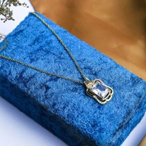 Timeless Elegance Shines Through In This Gold Necklace, Studded With Radiant Zircon And A Colorful Gem