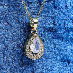 A Refined Gold Necklace With A Teardrop Design, Featuring A Sparkling Colored Gemstone Encircled By Brilliant Diamonds