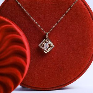 A Modern Gold Necklace Adorned With An Oval Colored Gemstone, Set In A Frame Of Gold And Diamonds