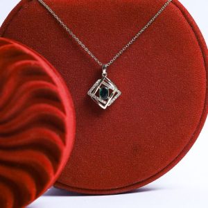A Modern Gold Necklace Adorned With An Oval Colored Gemstone, Set In A Frame Of Gold And Diamonds
