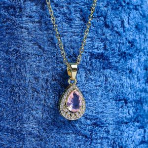 A Refined Gold Necklace With A Teardrop Design, Featuring A Sparkling Colored Gemstone Encircled By Brilliant Diamonds