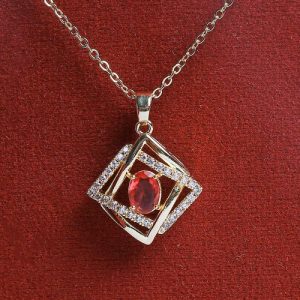 A Modern Gold Necklace Adorned With An Oval Colored Gemstone, Set In A Frame Of Gold And Diamonds