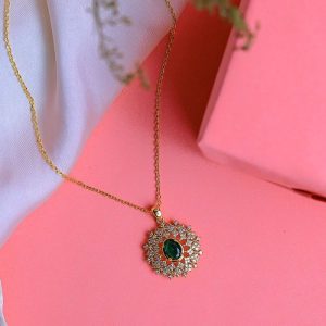 Sleek Design Featuring A Gold Necklace With Shimmering Zircon And An Attractive Colorful Gem