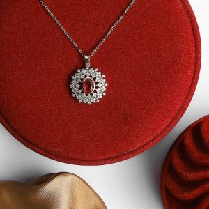 Sleek Design Featuring A Gold Necklace With Shimmering Zircon And An Attractive Colorful Gem