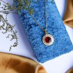 Sleek Design Featuring A Gold Necklace With Shimmering Zircon And An Attractive Colorful Gem