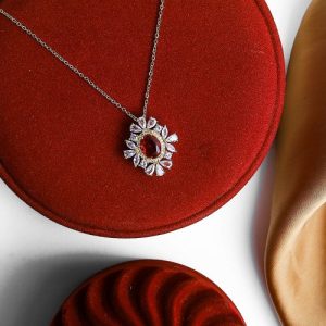 Delicate Gold Necklace With Gleaming Zircon Stones And A Light-reflecting Colorful Gem