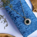 Sleek Design Featuring A Gold Necklace With Shimmering Zircon And An Attractive Colorful Gem