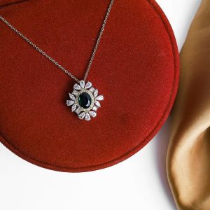 Delicate Gold Necklace With Gleaming Zircon Stones And A Light-reflecting Colorful Gem