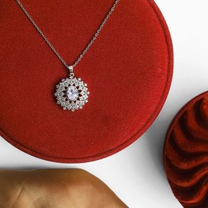 Sleek Design Featuring A Gold Necklace With Shimmering Zircon And An Attractive Colorful Gem